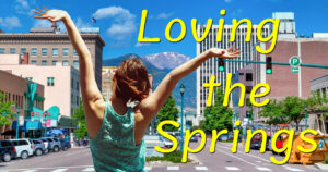 Loving the Springs, woman embraces view of Pikes Peak in downtown Colorado Springs